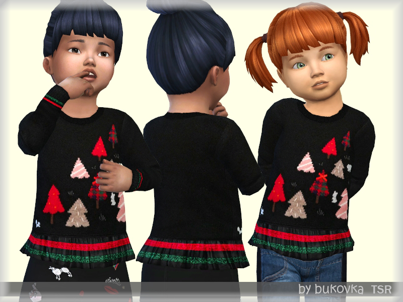 Drei Sims im Kleinkindalter tragen schwarze Weihnachtspullover mit kleinen Bäumen in verschiedenen Farben