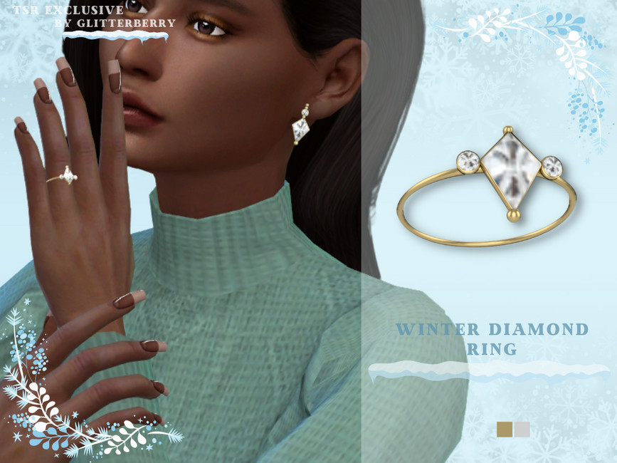 Ein Diamantring mit einem dünnen goldenen Band, dieser hat eine große diamantförmige Mitte und an jedem Ende befindet sich eine kleine Metallkugel. Auf beiden Seiten des Diamanten am Band befindet sich ein kleiner Diamant.